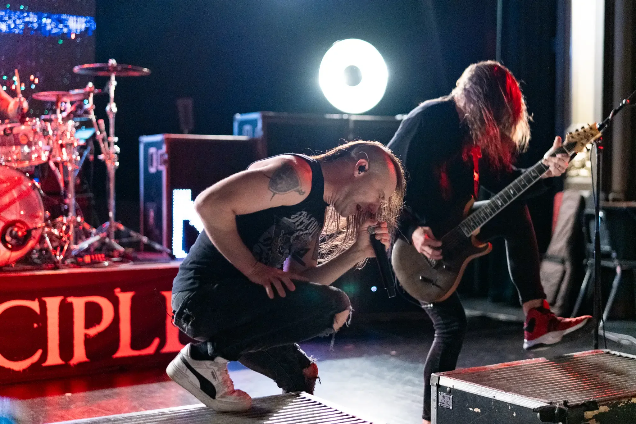 Guitarist and bassist on a lit stage mid show