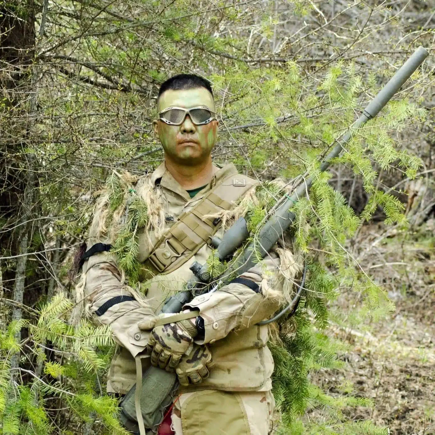 Eric in camouflage and goggles in the trees
